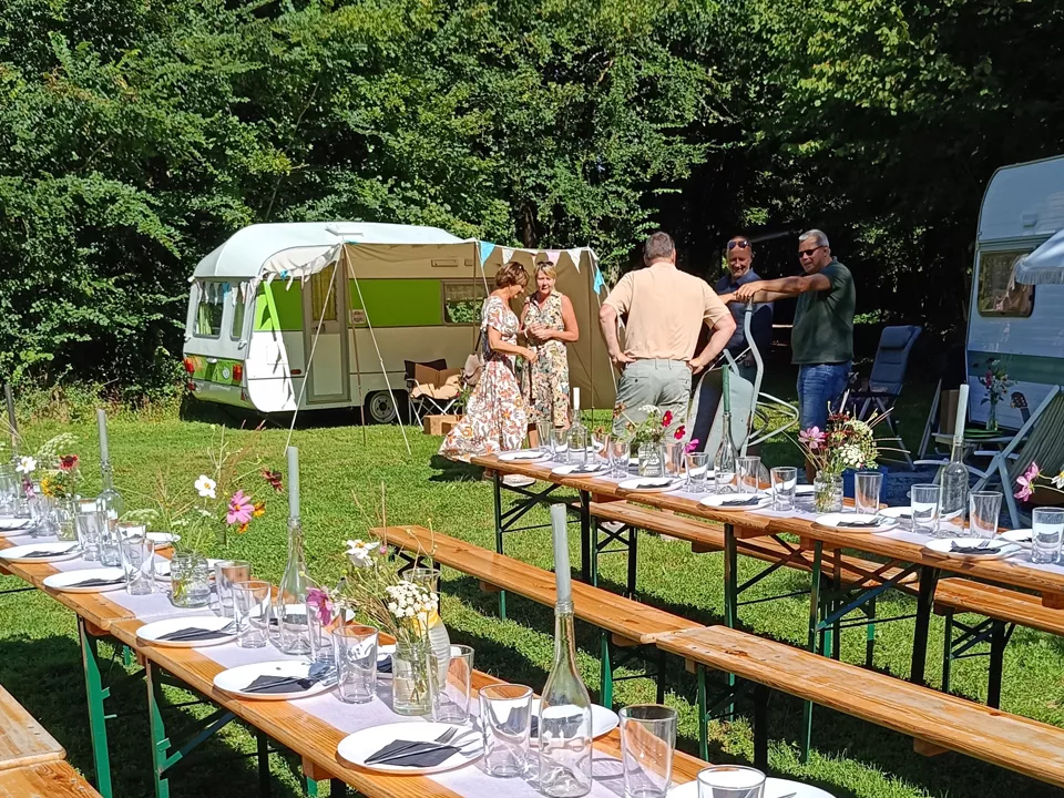 Een familie bij hun verblijf, enkele caravans